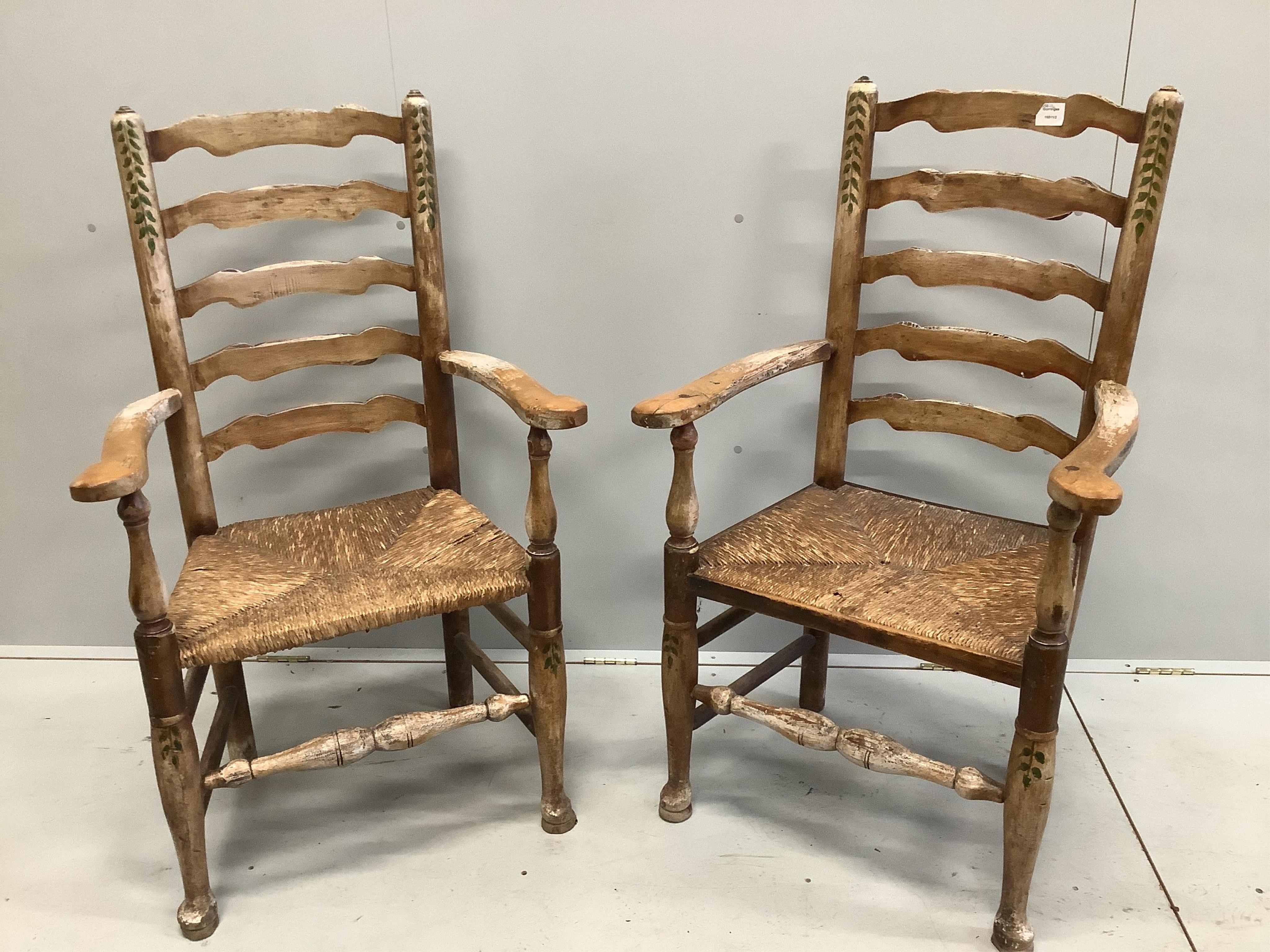 A pair of 19th century Provincial fruitwood rush seated ladder back elbow chairs, later painted, width 64cm, depth 48cm, height 112cm. Condition - poor to fair